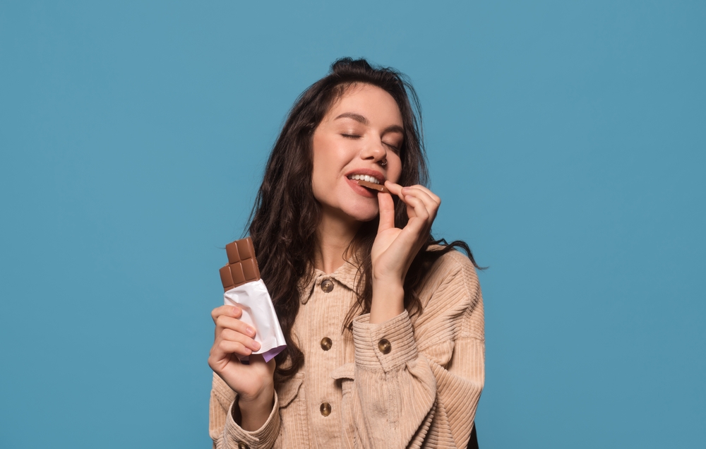 Woman eating chocolate.