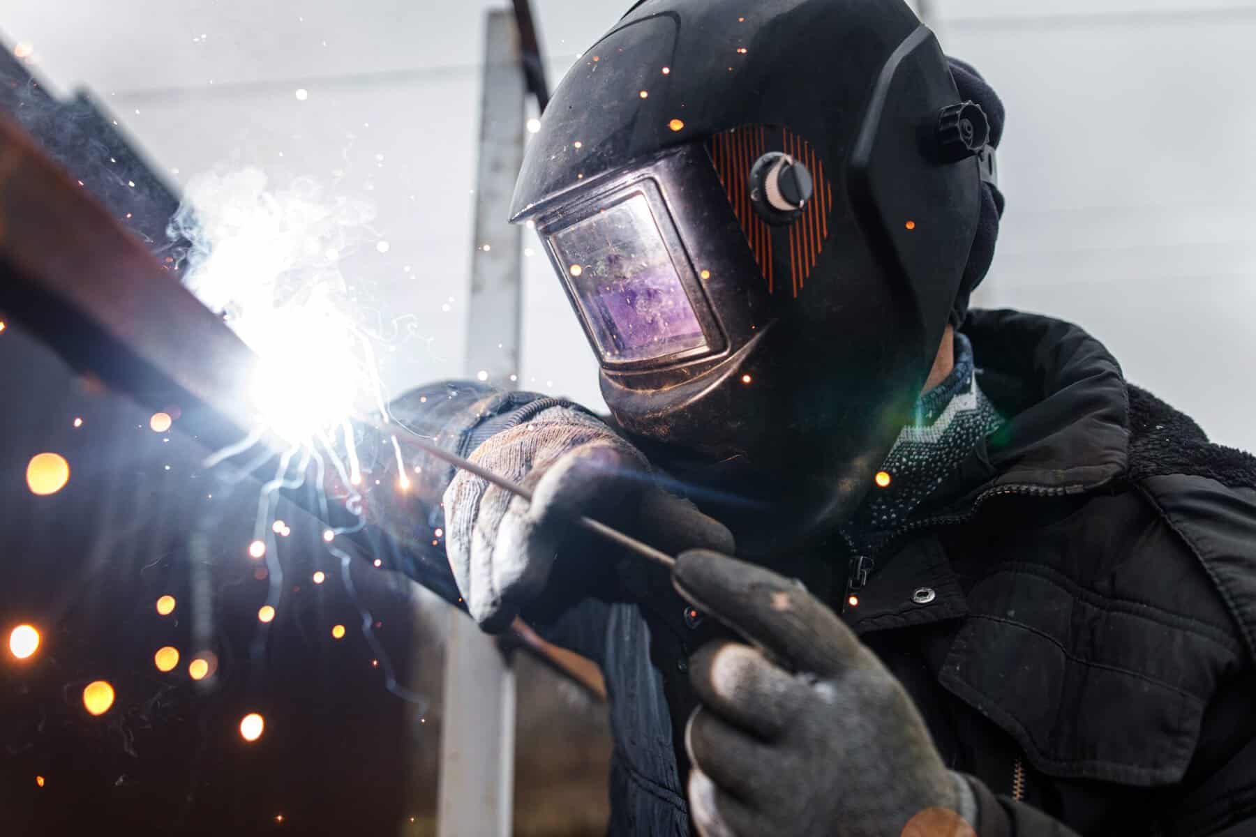 Man using a welding rod.