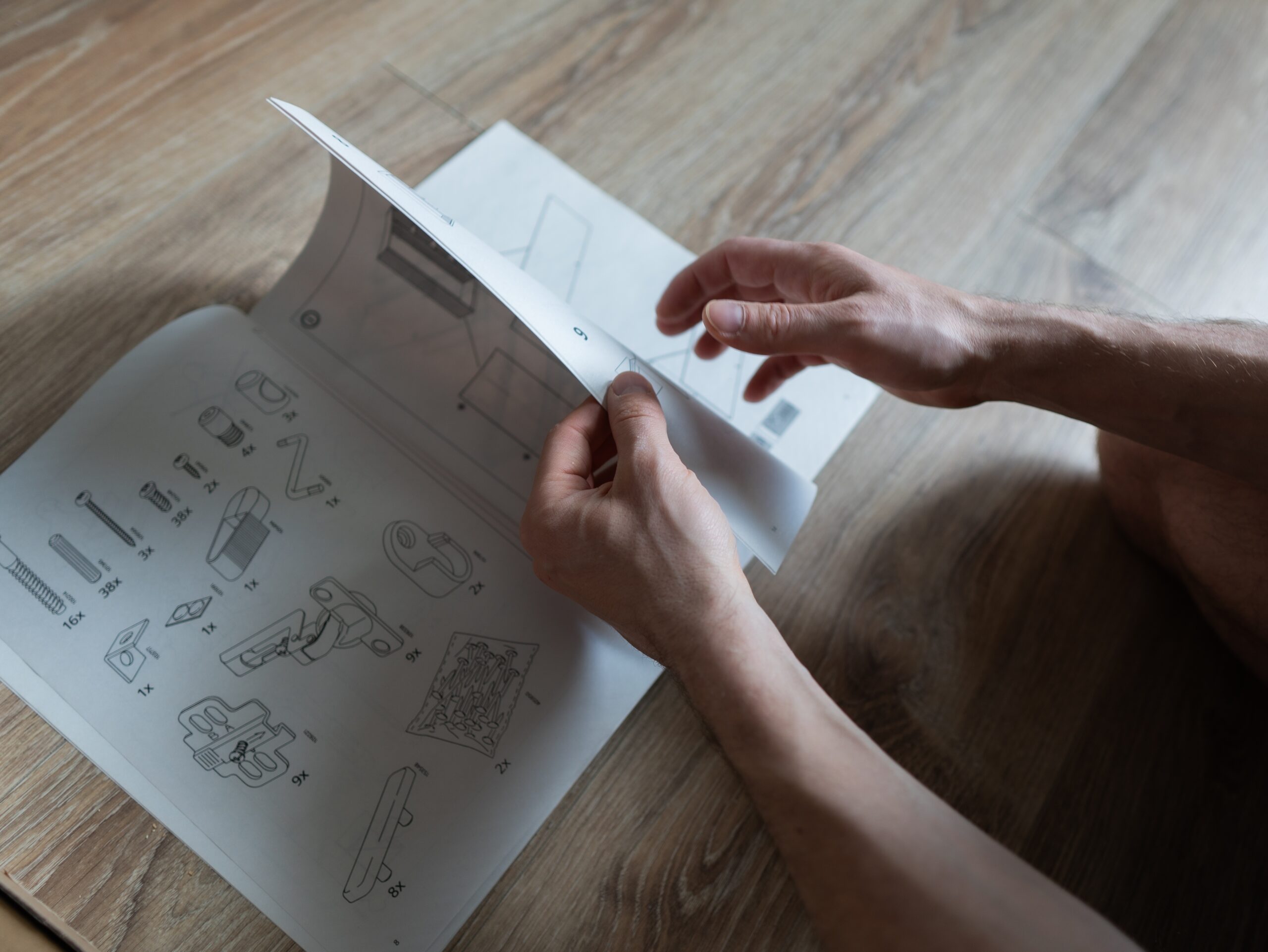 A man looking through an assembly manual.