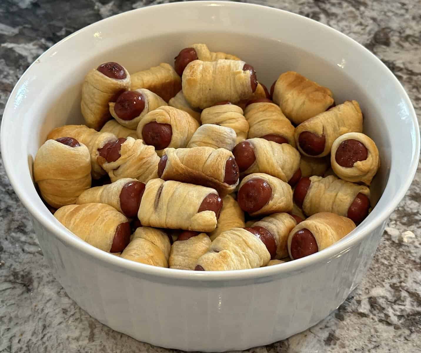 A bowl of pigs in a blanket.