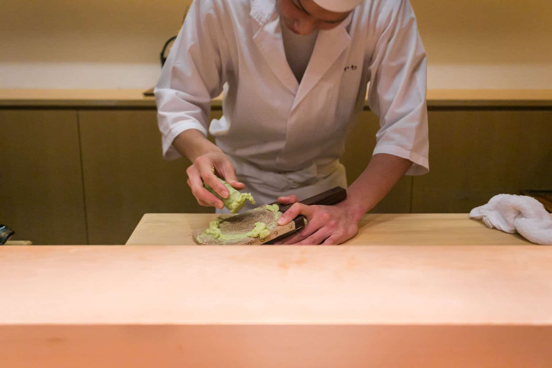A chef grating wasabi.