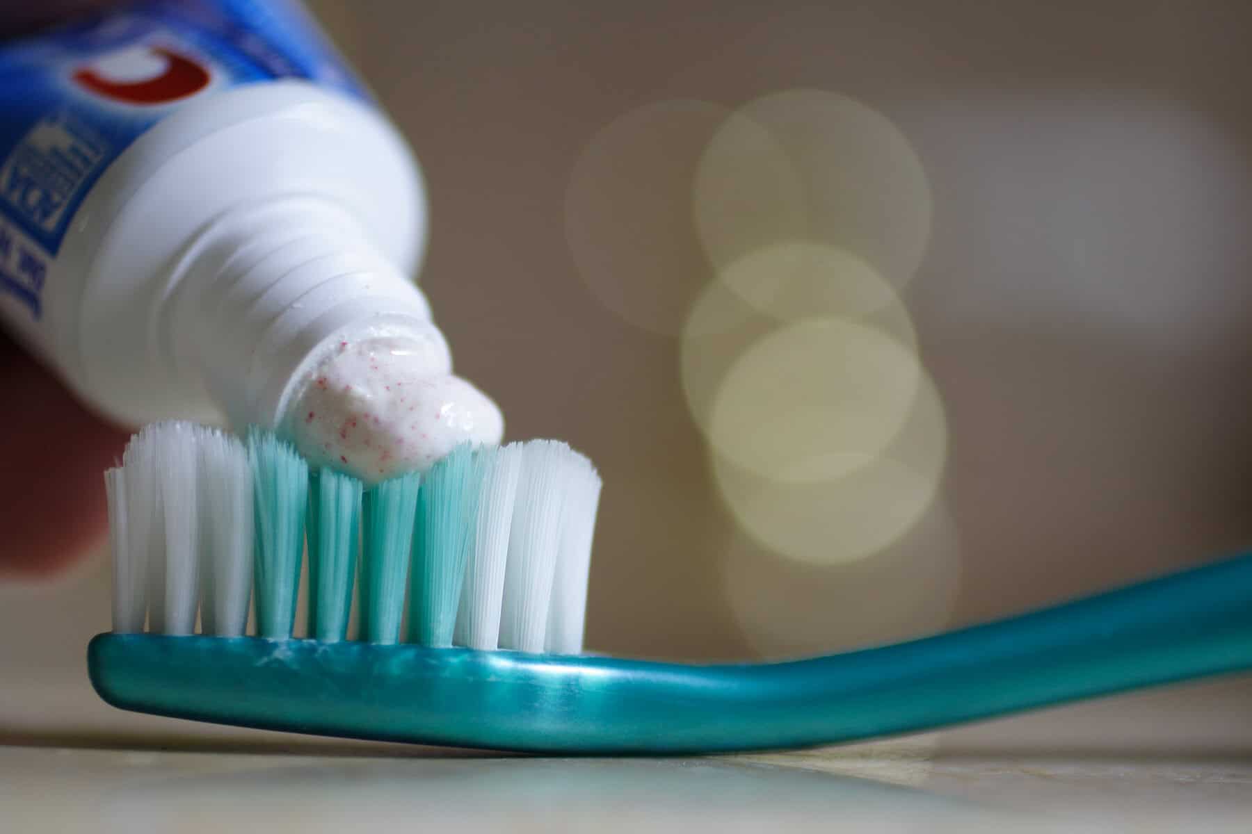 Toothpaste on a tooth brush.