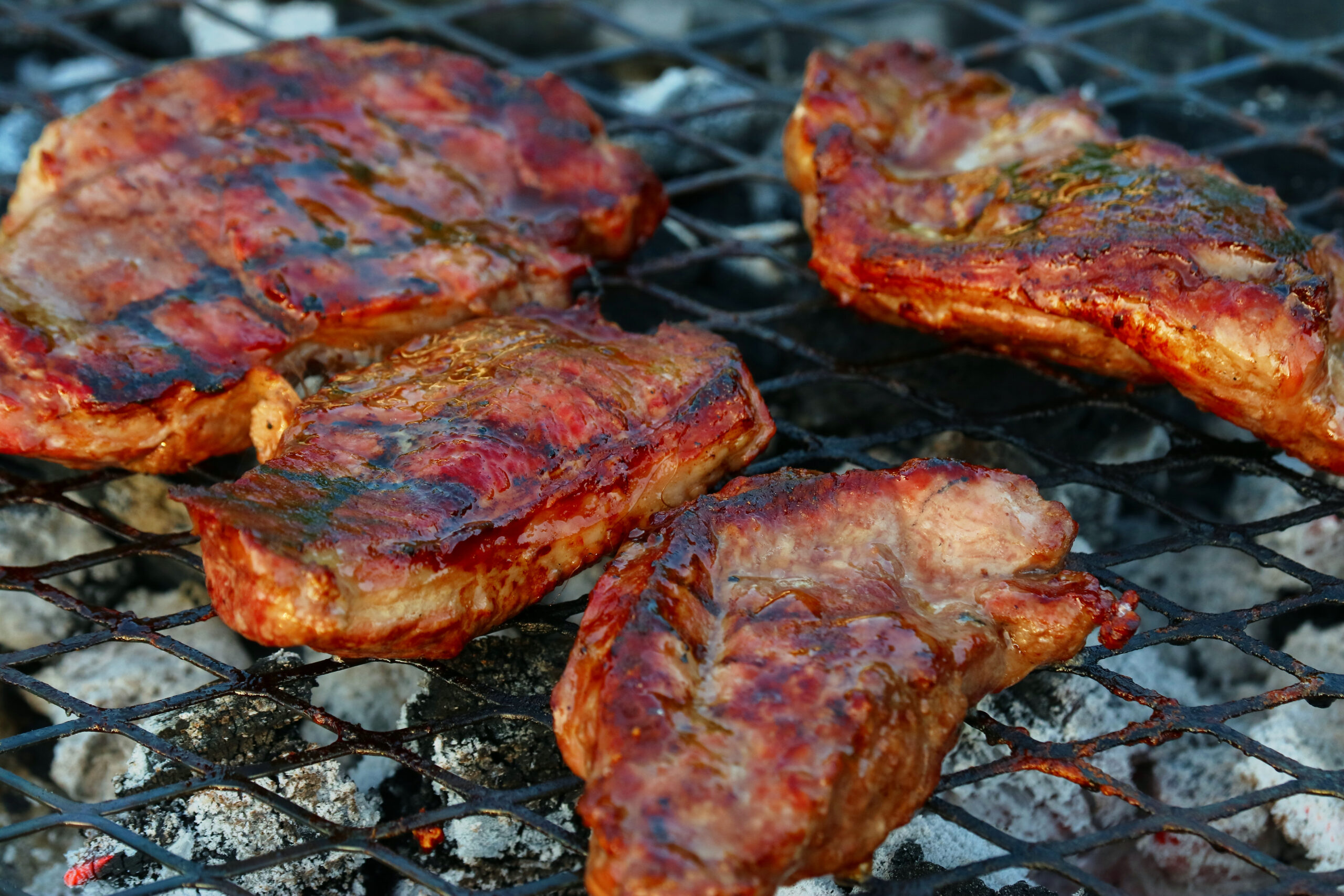 A BBQ grill with meat.