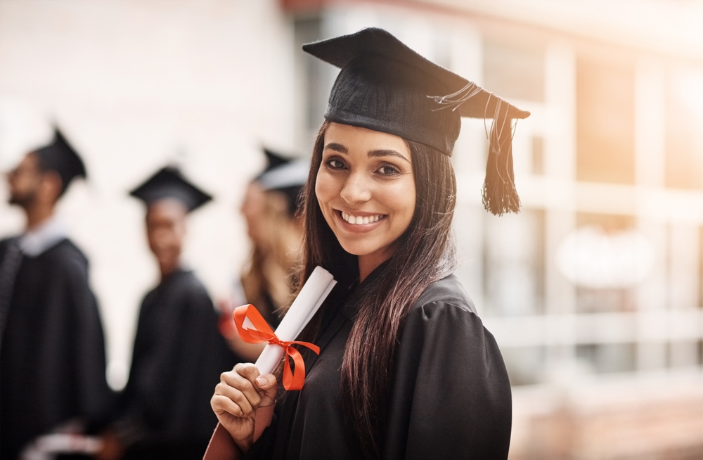 Graduate smiling in her cap and gown.
