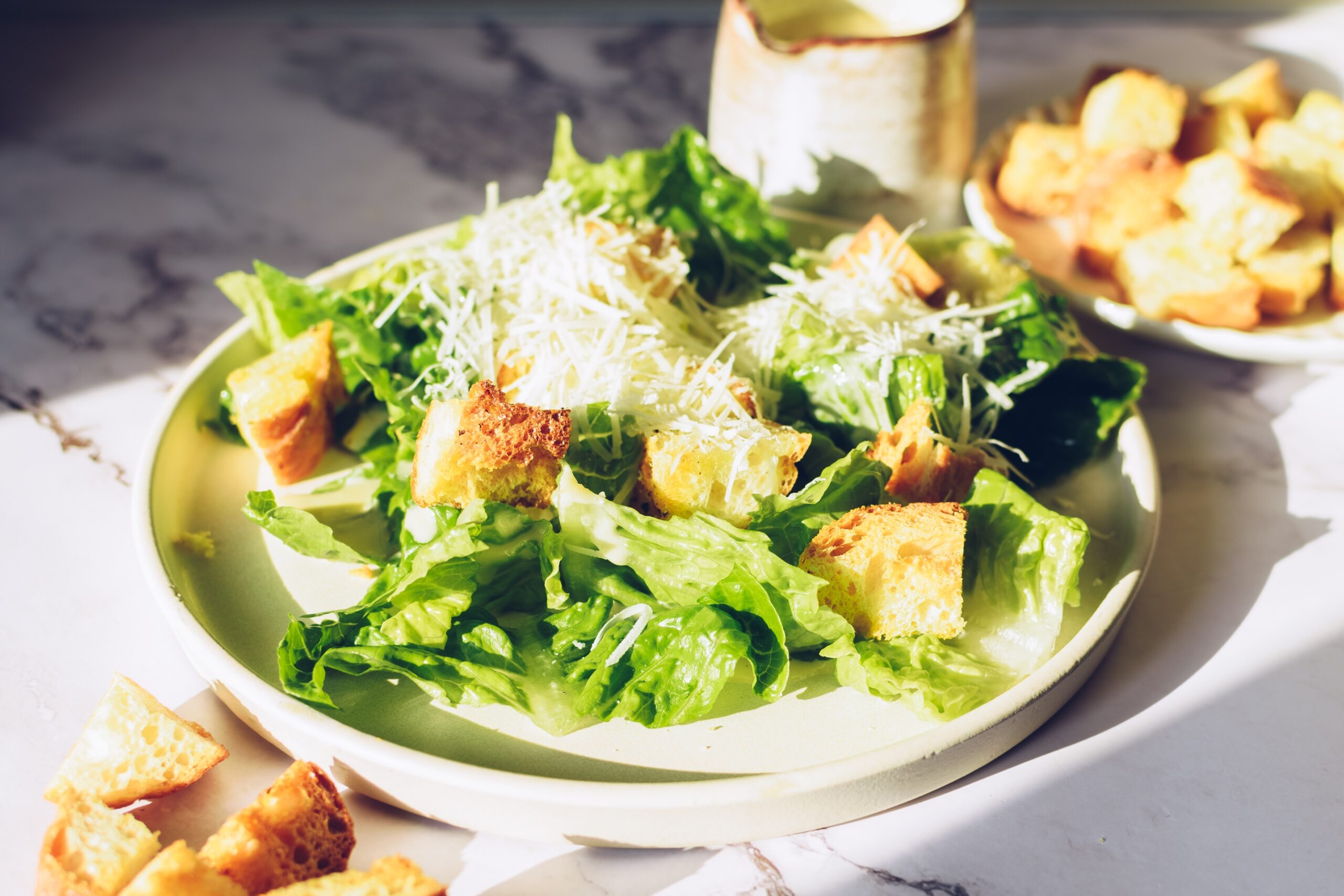 Classic caesar salad with lettuce, croutons and parmesan cheese.