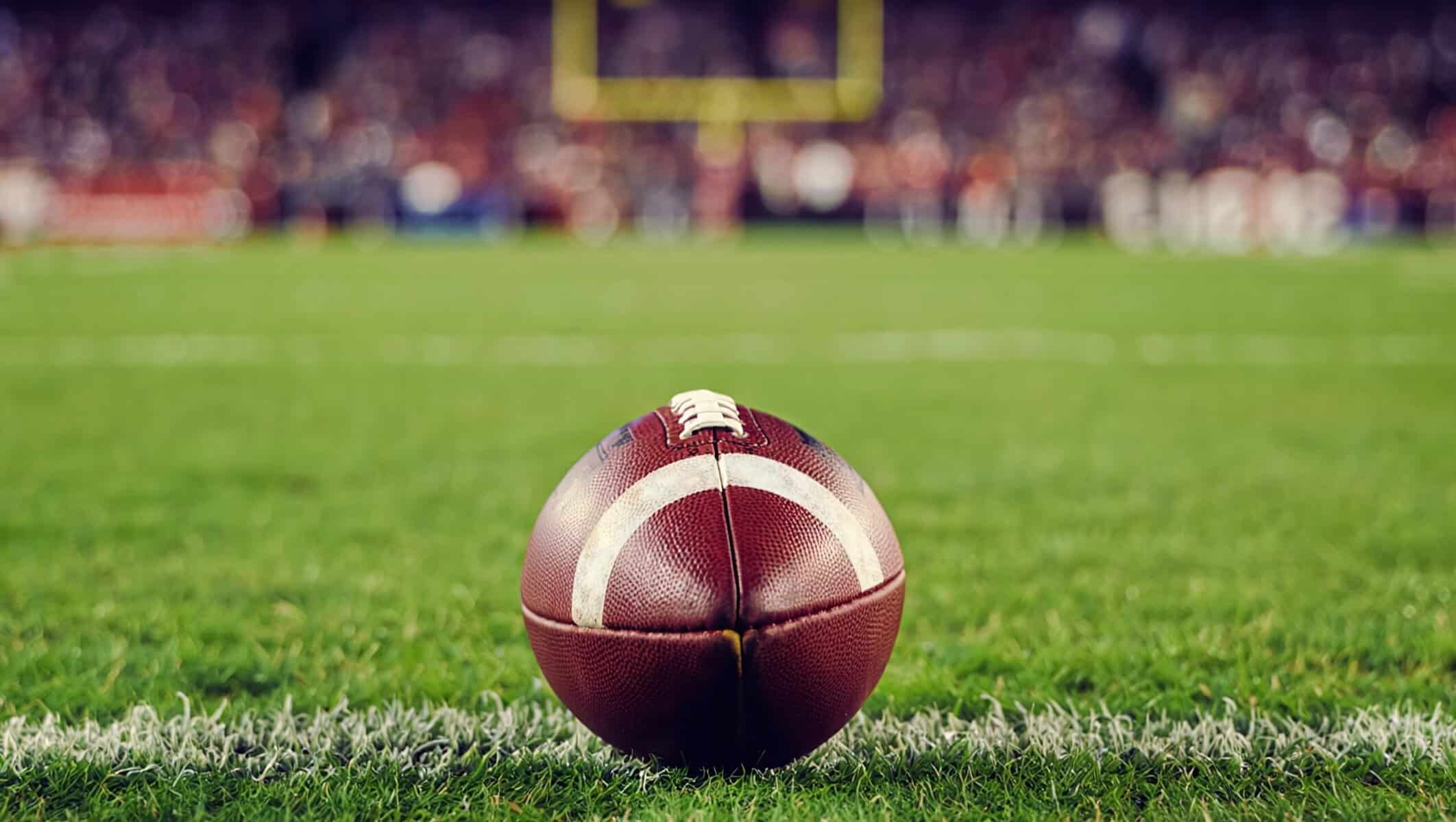 Closeup of a football on the field. 