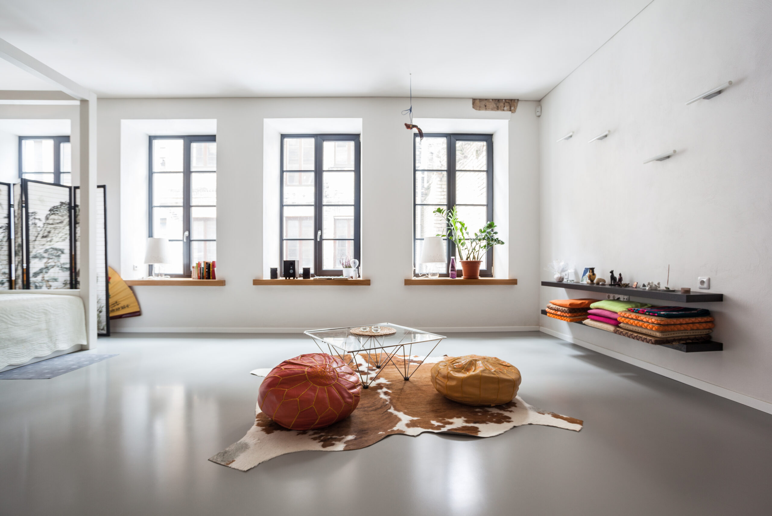 A cow skin rug in a living room.