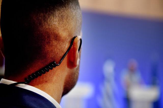 Security guard wears headset.