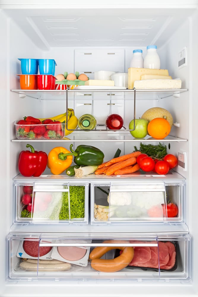 Open fridge stocked with food.