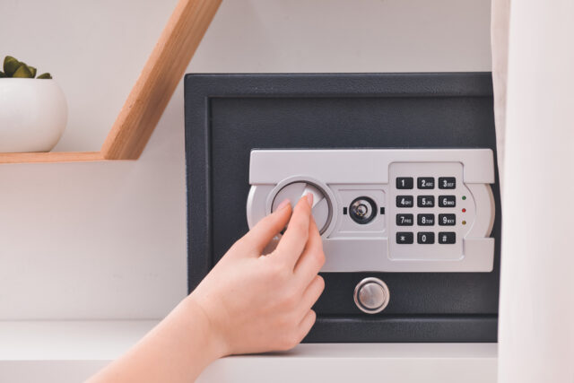 Hand opening home safe.