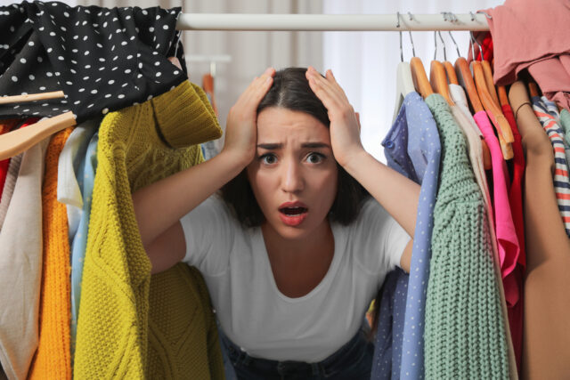 Young woman looking in her closet.