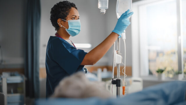 Hospital ward, Nurse attending to her patient.