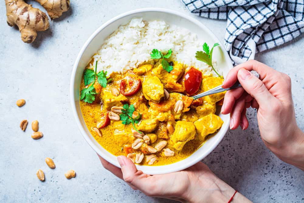Spicy chicken curry dish with white rice.