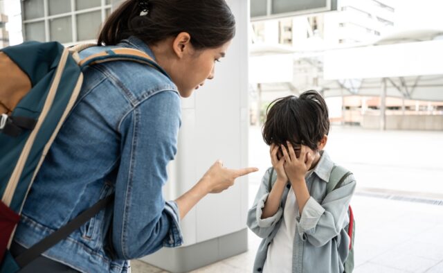 Mother yelling and scolding her young son in public.