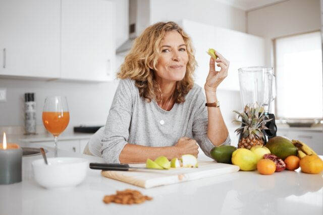 Woman making fruit salad.