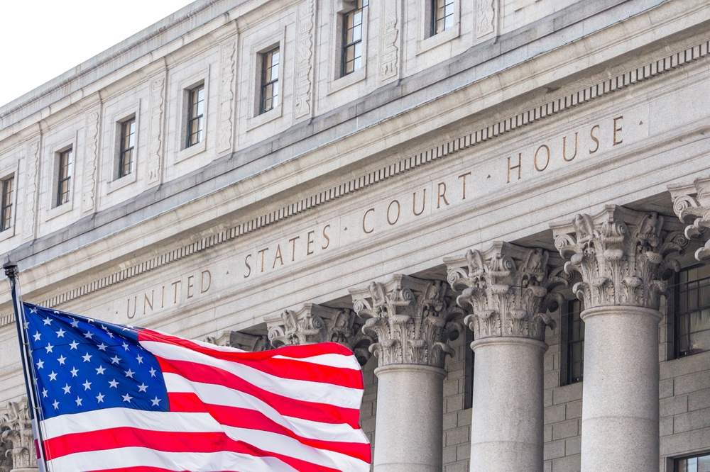 US flag waving in front of Supreme Courthouse.