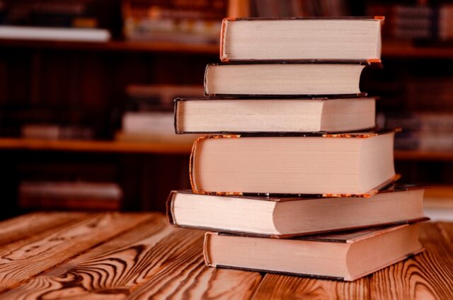 Old books on wooden stand.