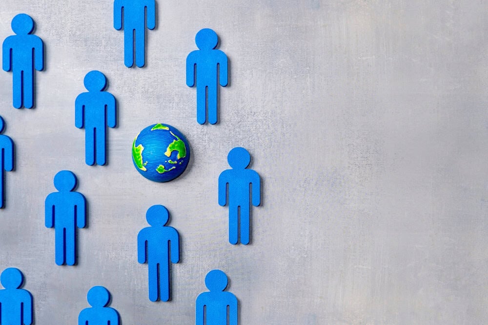 World globe surrounded by blue human figures.