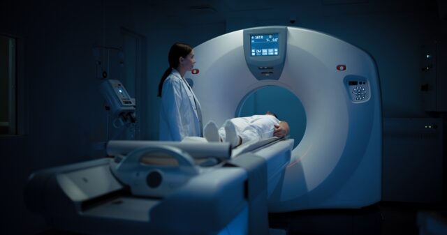 Radiologist controlling MRI, CT Pet Scan Machine.