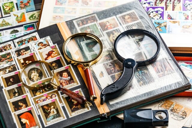 Postage stamp collection with magnifying glass
