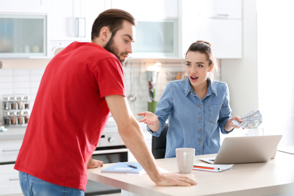 A young couple arguing about finances, and how much they should spend or save