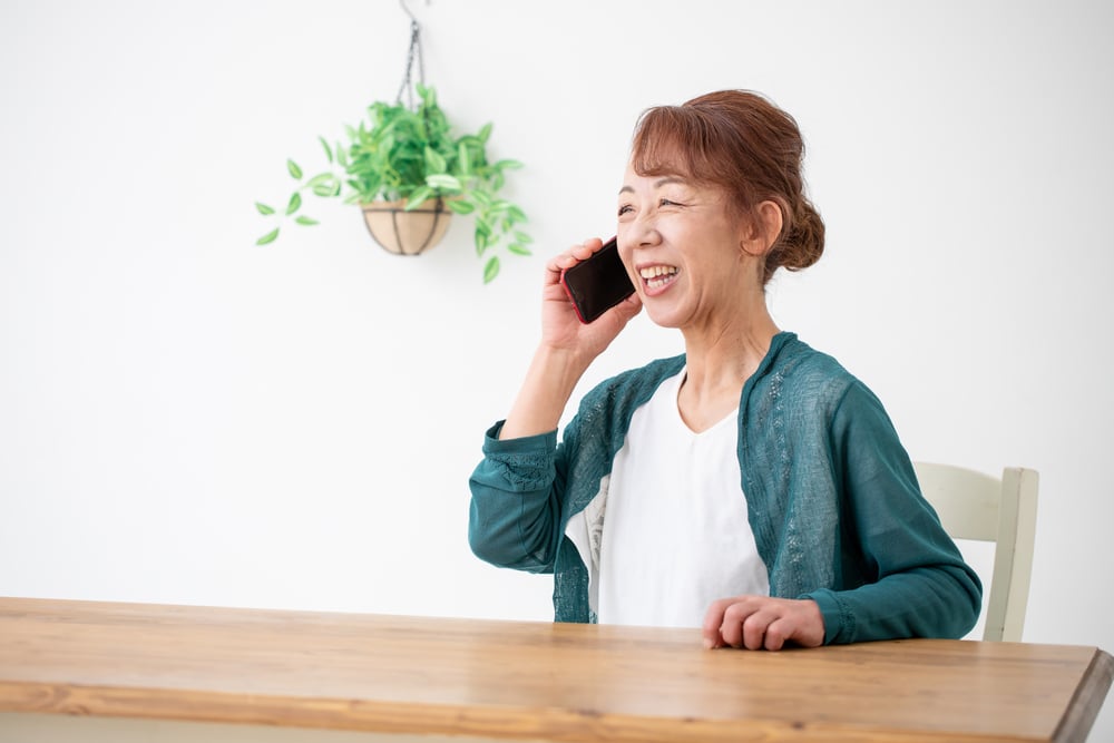A senior Asian woman making a phone call with her smartphone