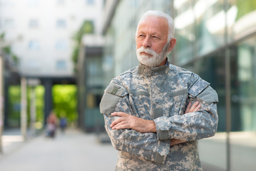 A senior soldier in military uniform out on a walk.