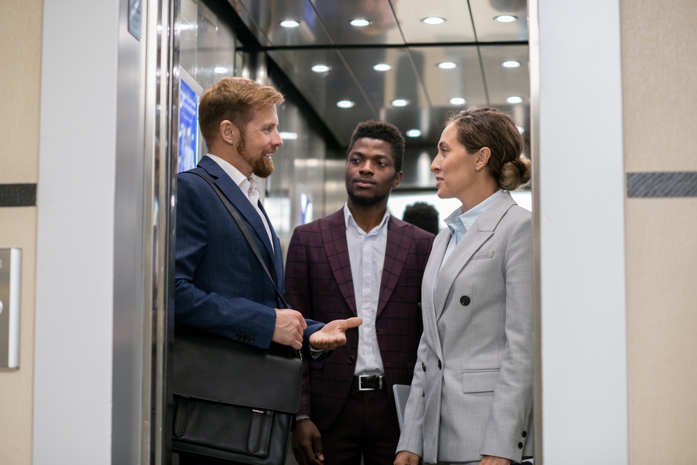 Business people discussing in an elevator