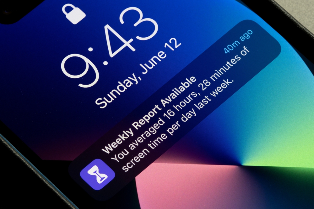 A locked iPhone screen showing notification that the phone usage weekly report is available