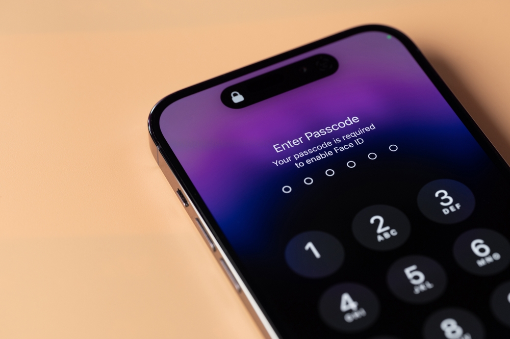 An iPhone on the table showing the "enter passcode screen"