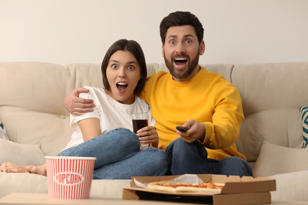 Surprised couple watching TV