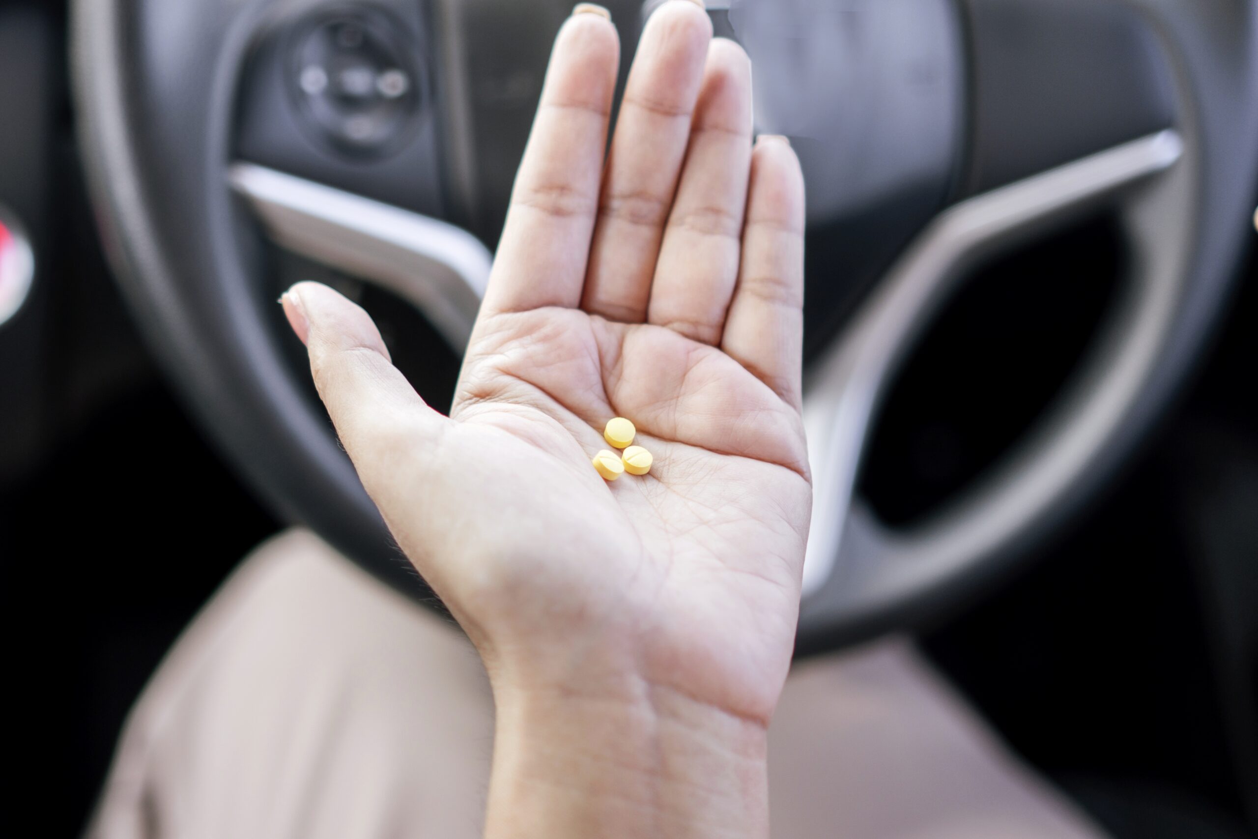 drugs pills medication on a woman's hand