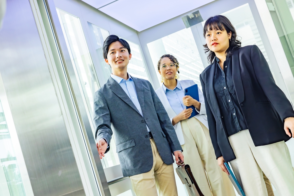 Asian business people in an elevator