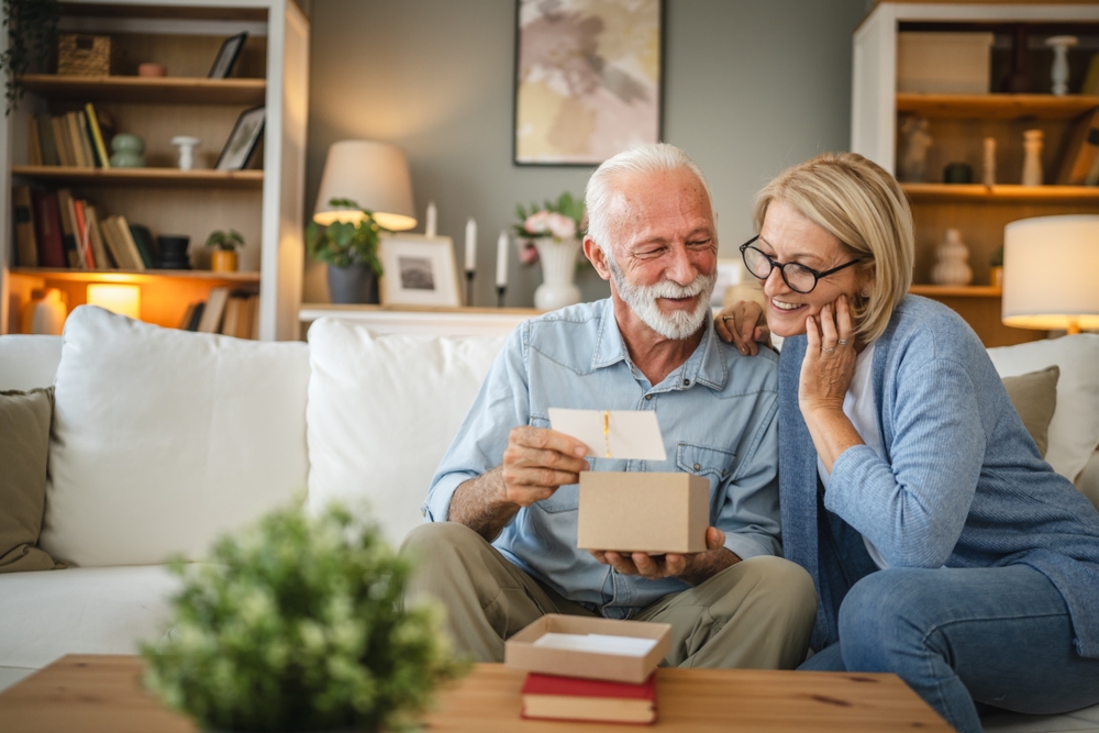 Senior husband reading greeting cards with senior wife