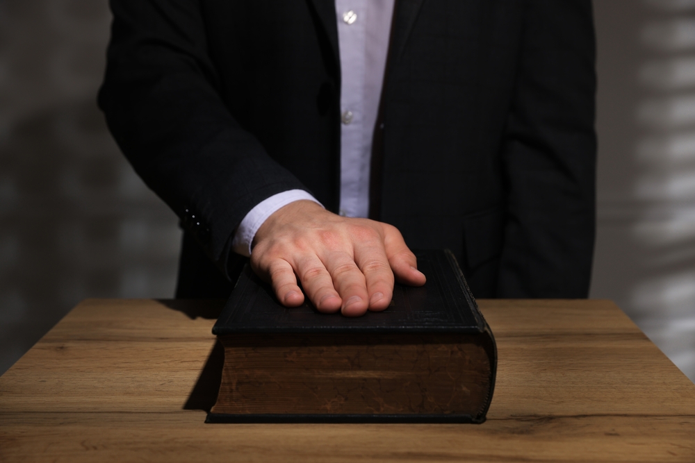 A man taking an oath of office with his hand on a bible