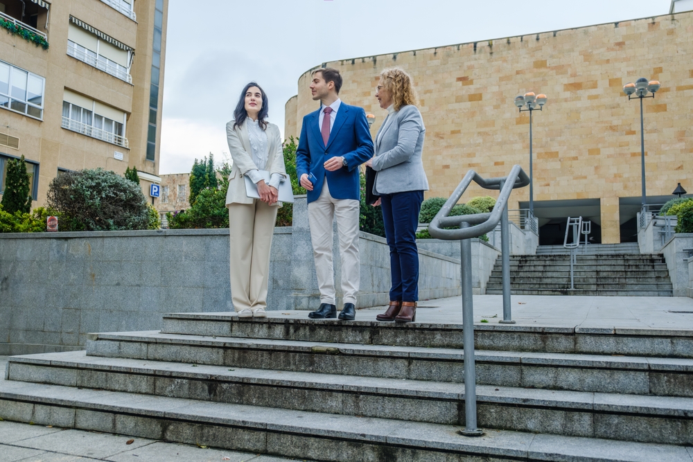 Three politicians standing outside and discussing city issues