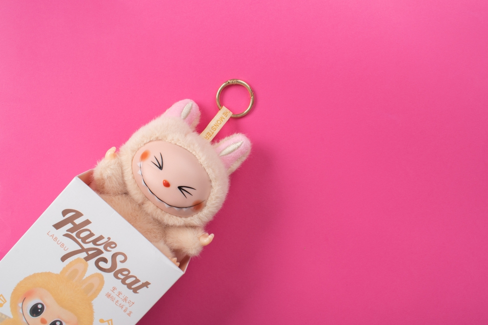 A special design of Labubu doll peeking out of its carton