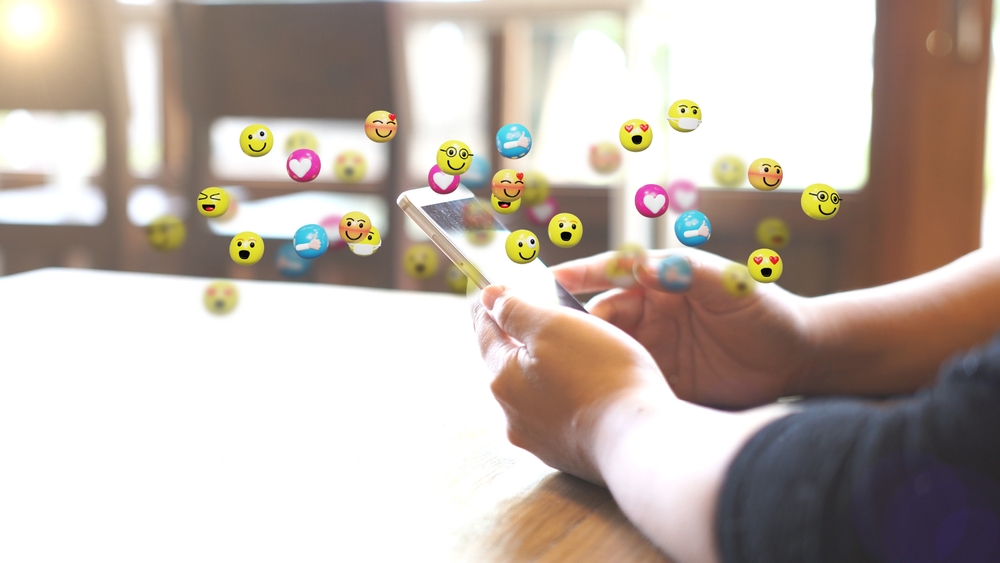 Woman using emojis on social media