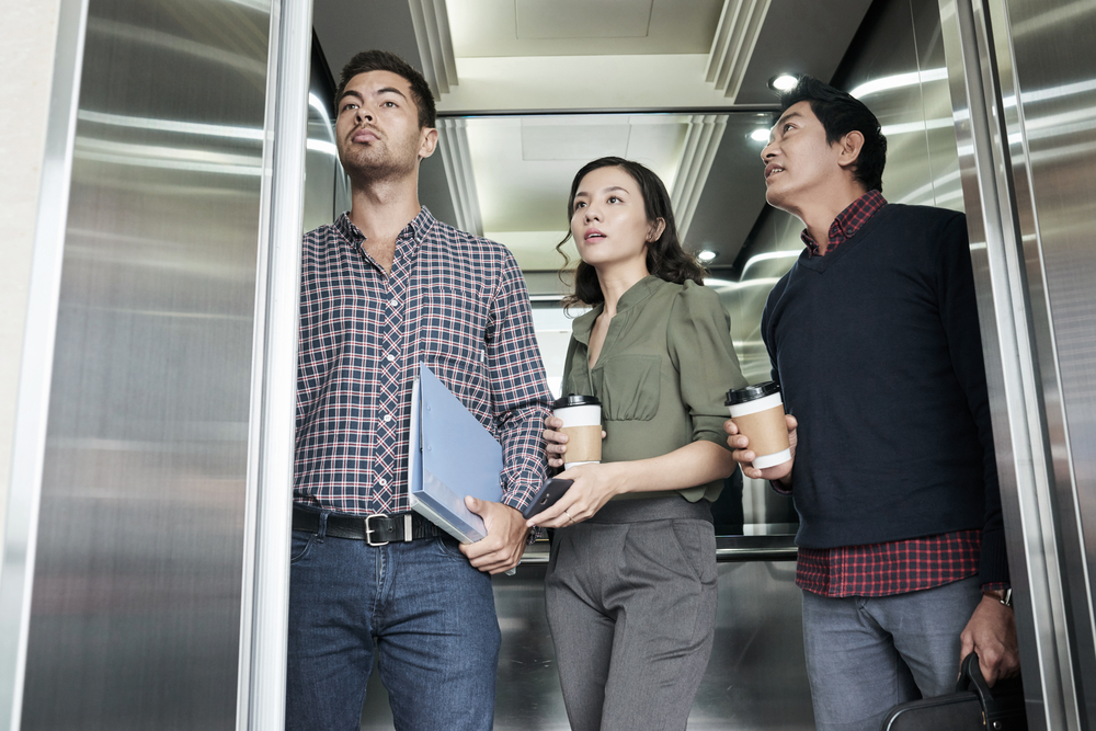 Business people in an elevator in their office building