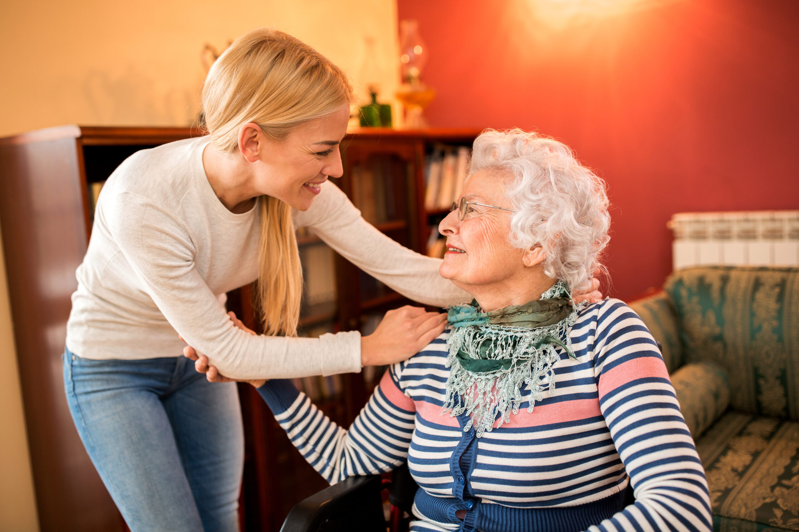 A smiling grandmother with her visiting granddaughter.