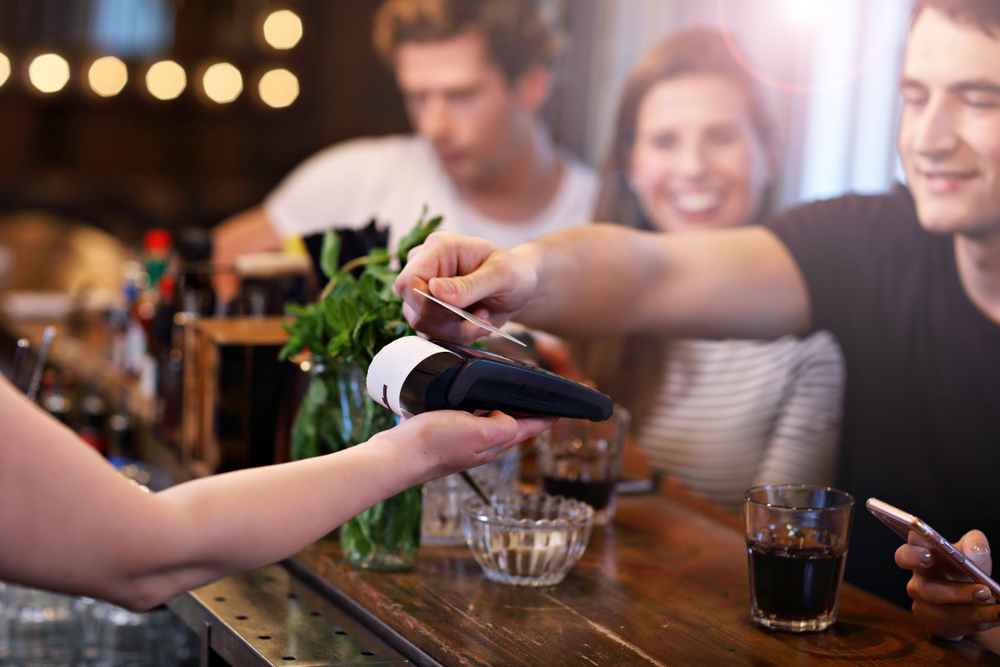 A man paying bill for his group of friends