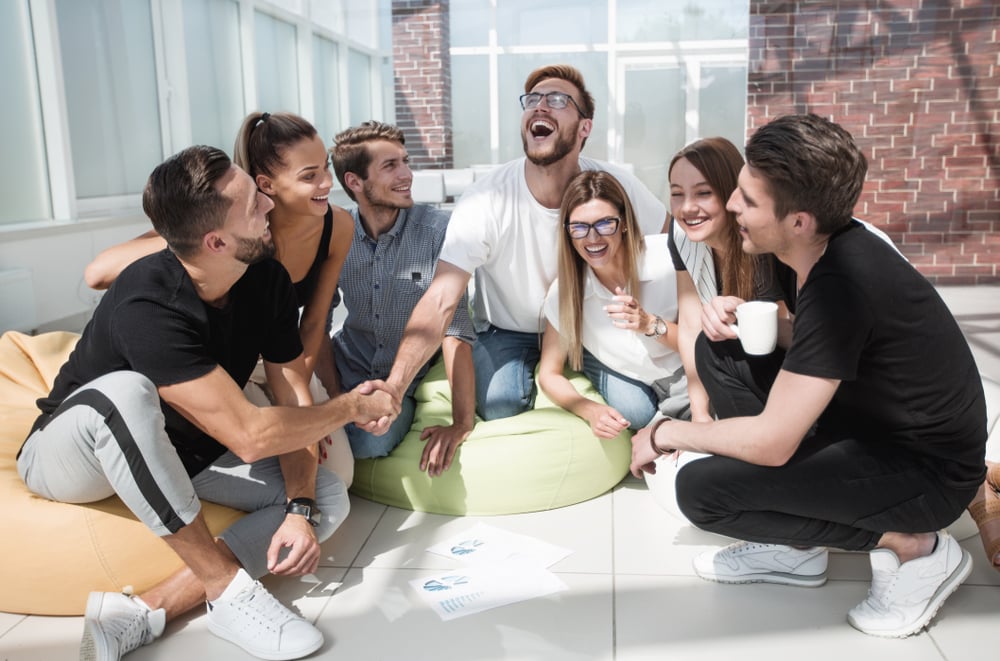 Friends shaking hands while discussing and having fun