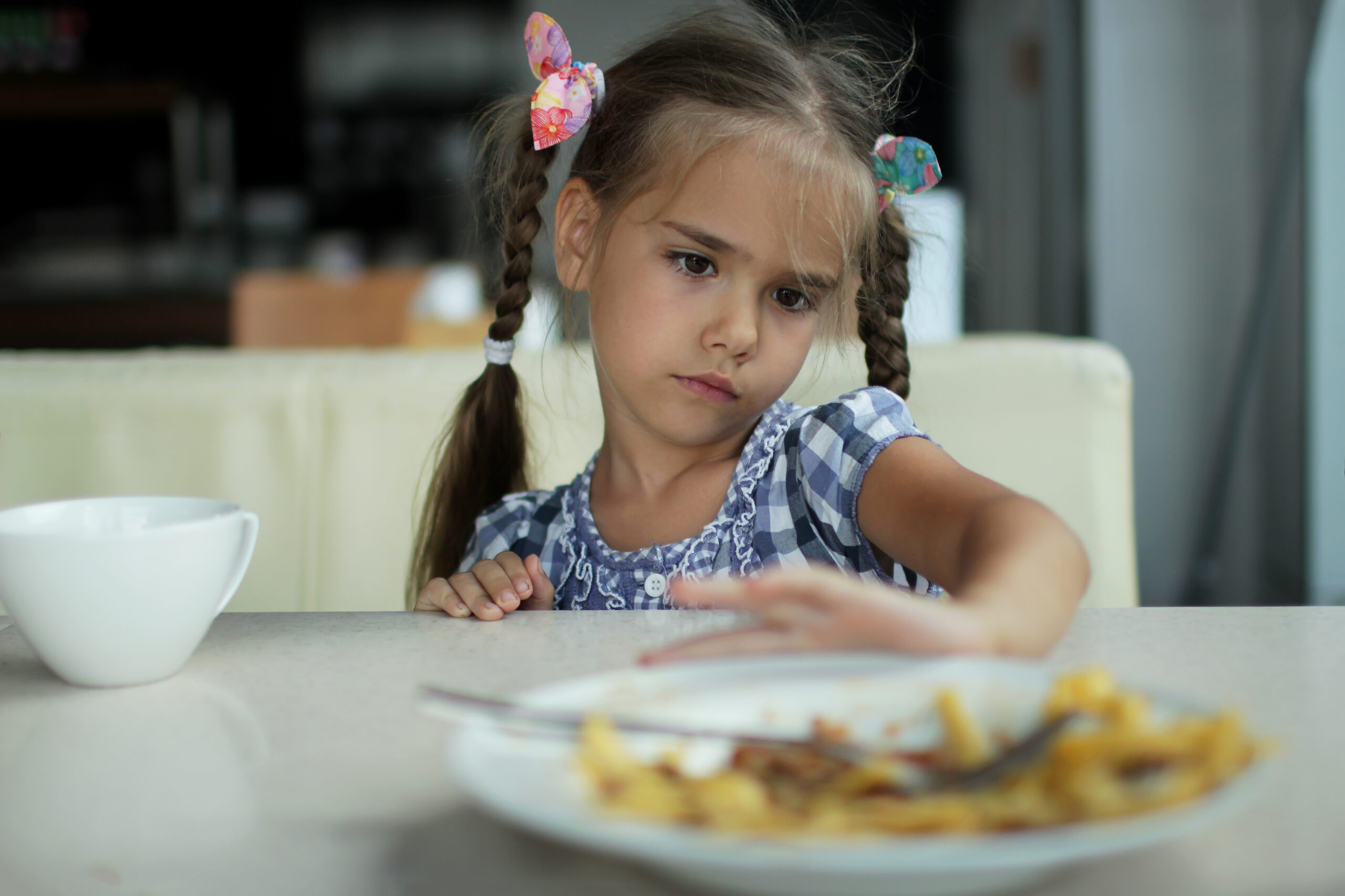 Child pushing away a plate of food.