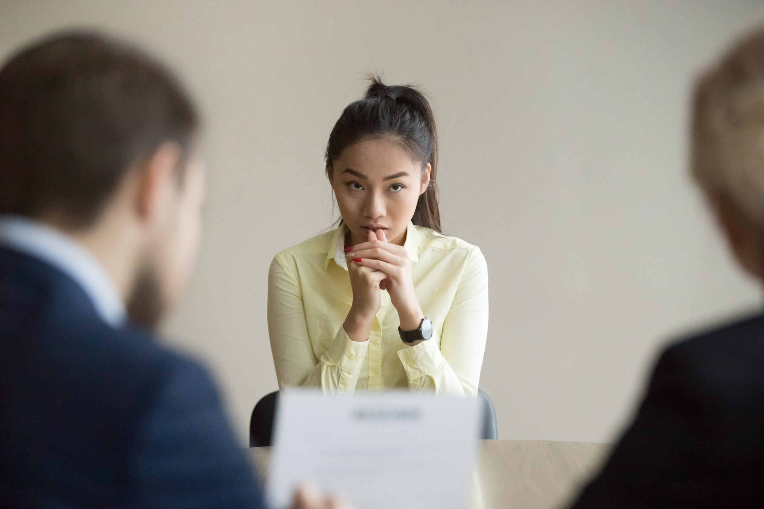 A smart young woman too nervous to ask for a promotion at work.