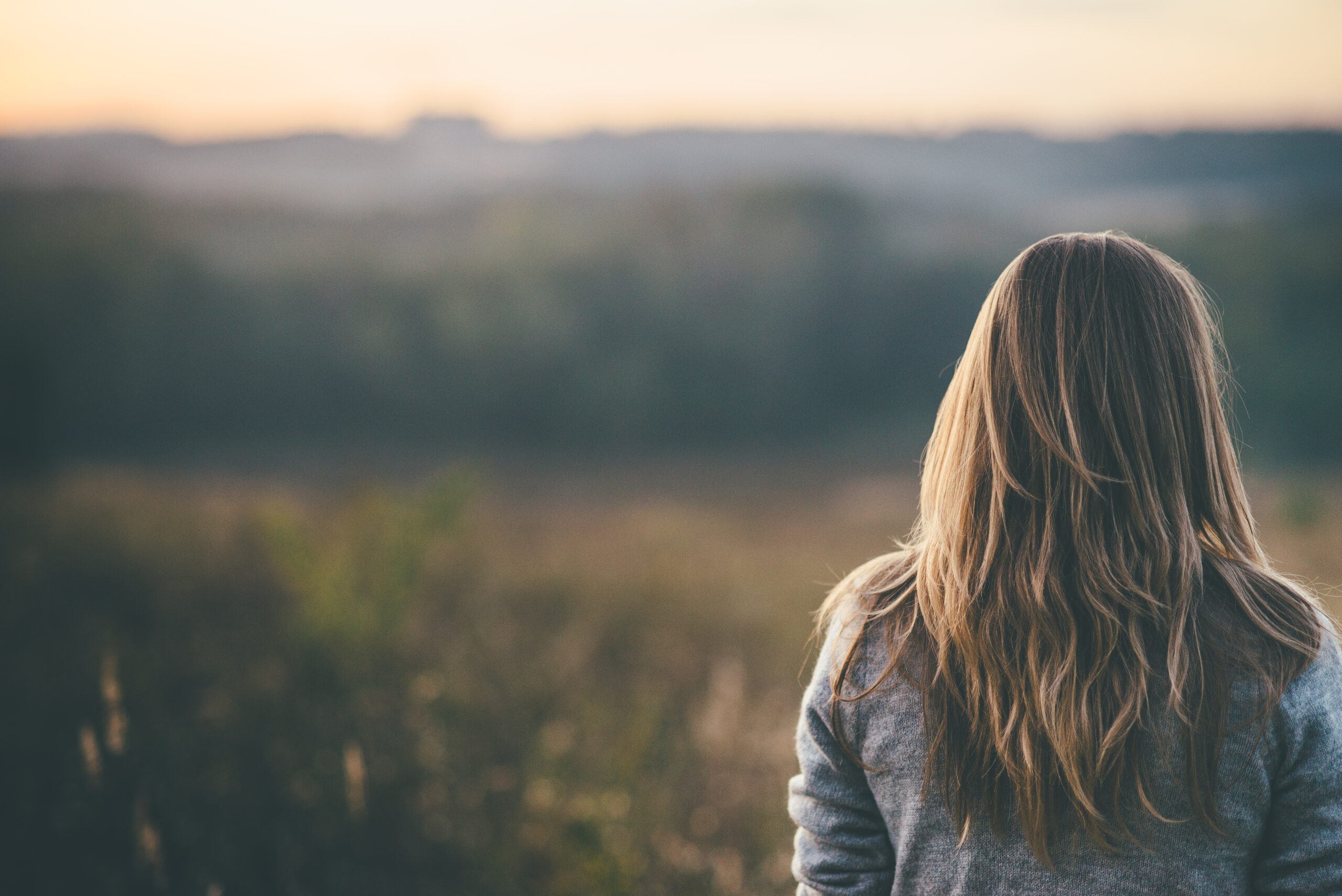 Woman alone in nature, without friends.
