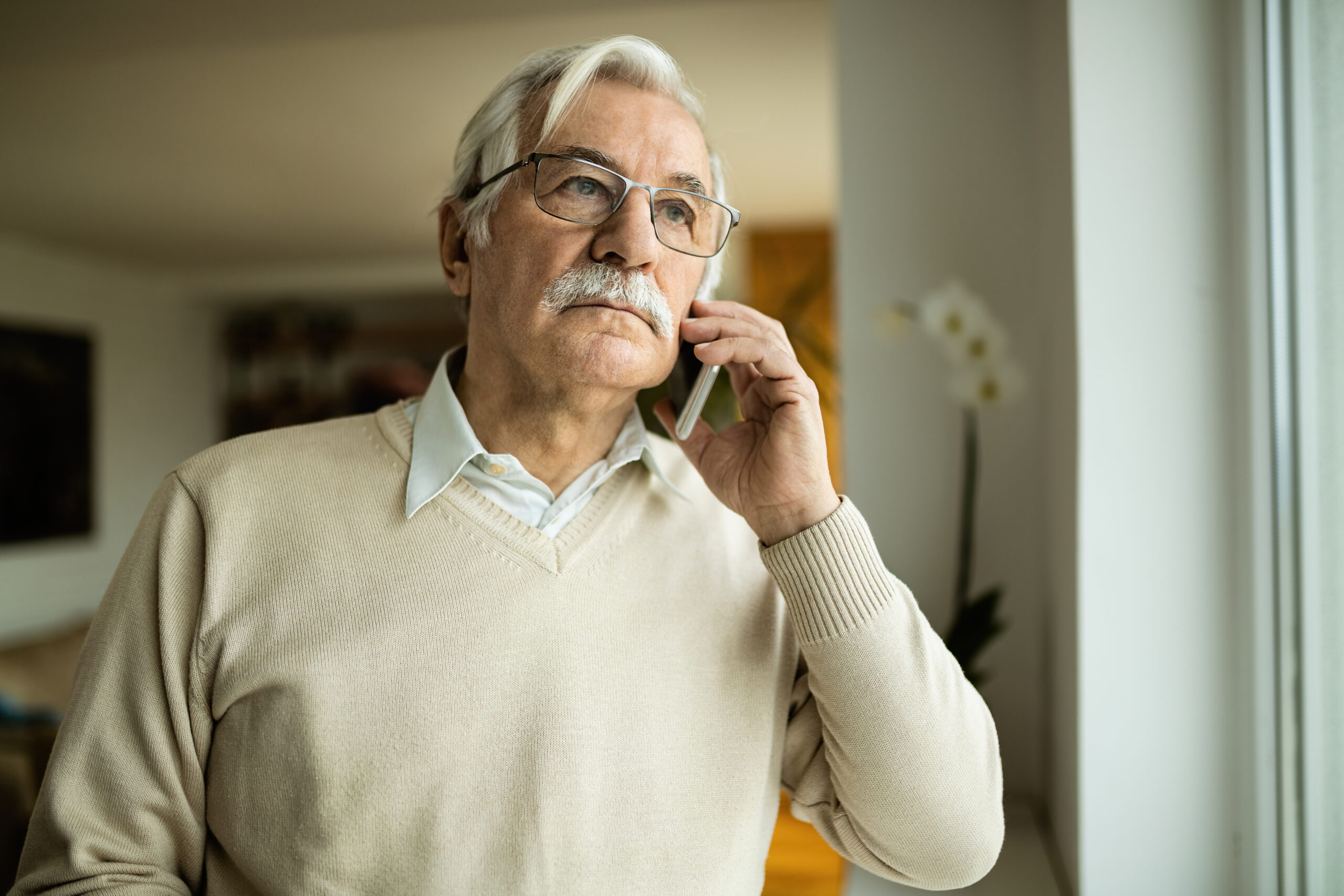 A mature man on the phone with his adult child.