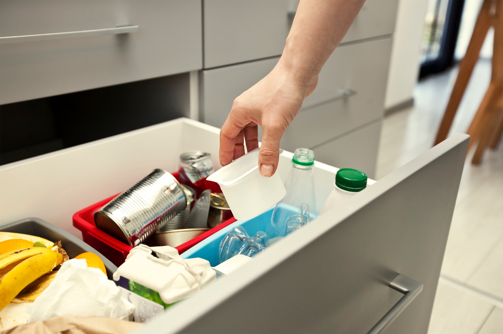 A man checking through his kitchen junk drawer