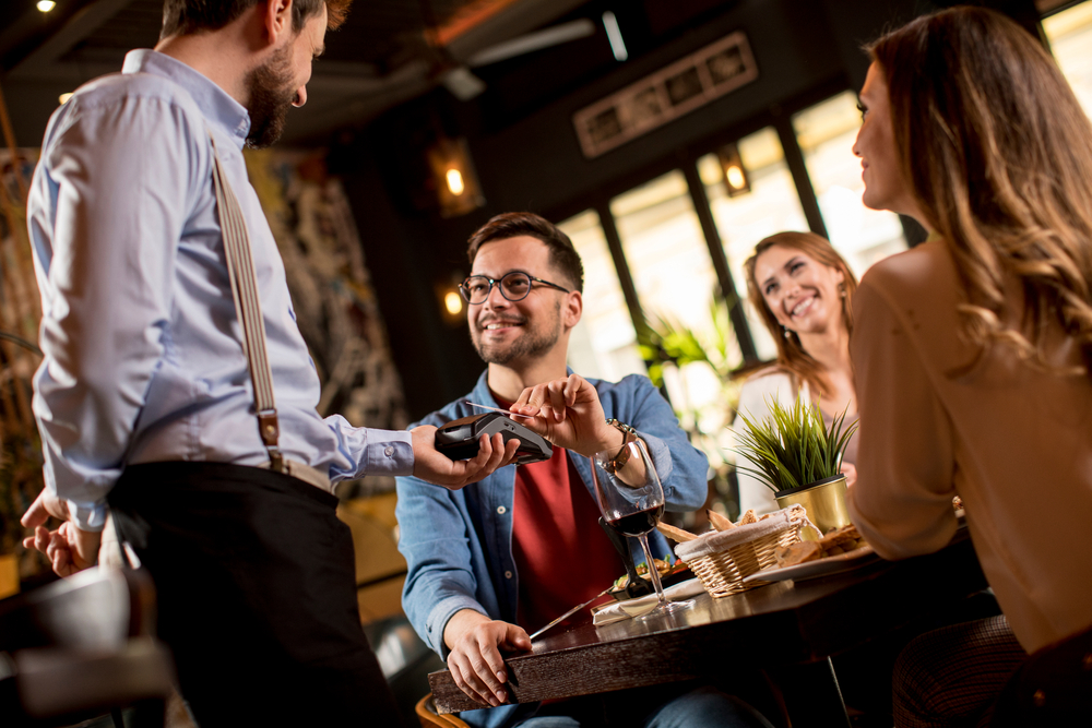 A man paying his dinner bill