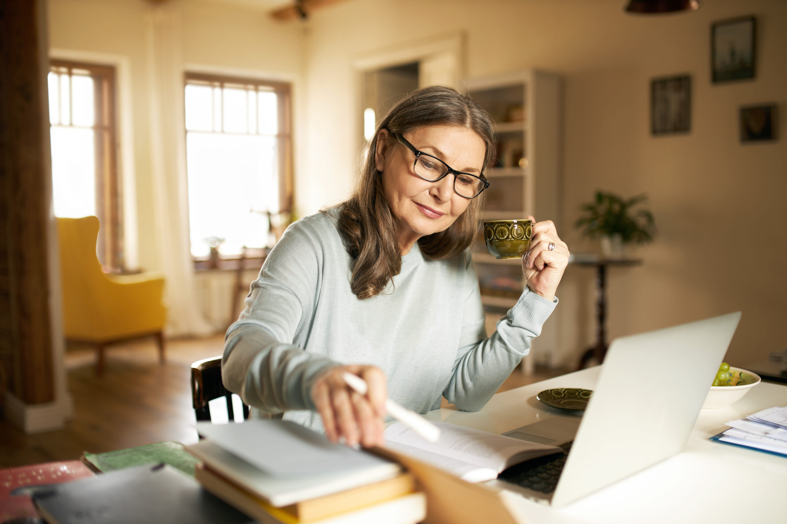 A confident middle aged woman in her home office.