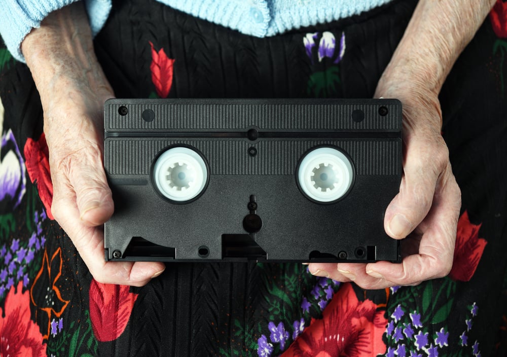 Senior woman and grandmother holding a vhs tape